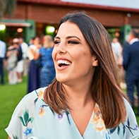 Woman smiling outside at wedding