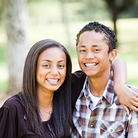 Two smiling teenagers with braces