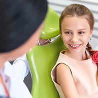 Smiling preteen girl in dental chair