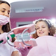 Little girl in dental chair learning to care for smile