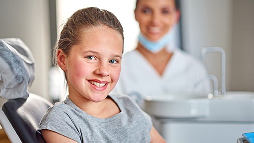 Young girl smiling in dental chair