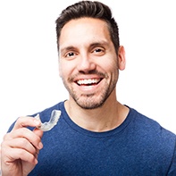 Man holding a clear alignment tray