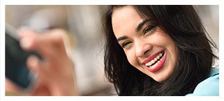 Smiling young woman taking selfie