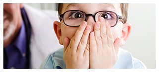 Young boy covering his mouth