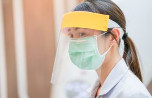 orthodontic team member wearing mask and face shield