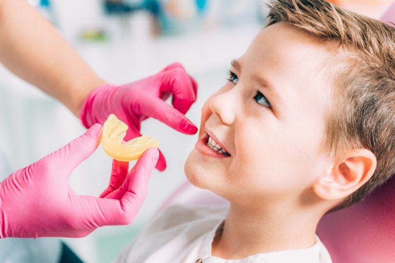 Little boy smiling at orthodontist during appointment