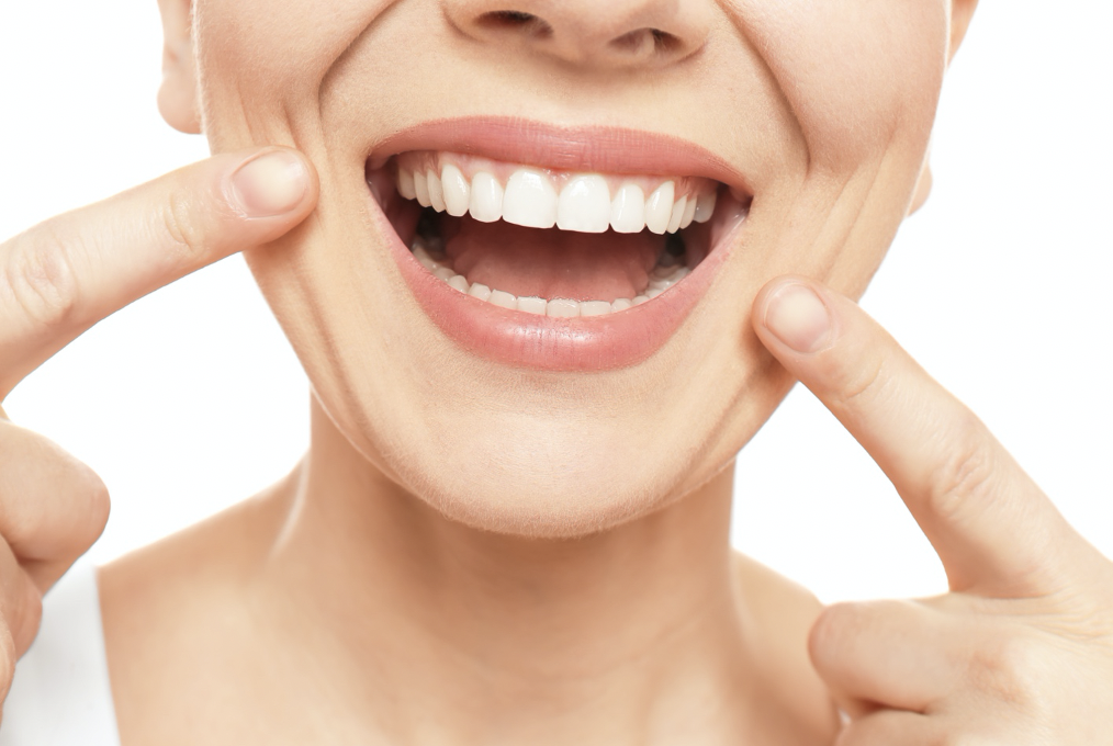 woman pointing at straight teeth 