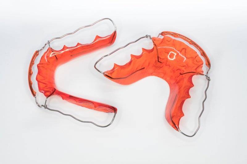 Two orthodontic retainers on a white background 