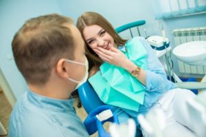 Young woman at the orthodontist having her braces removed.