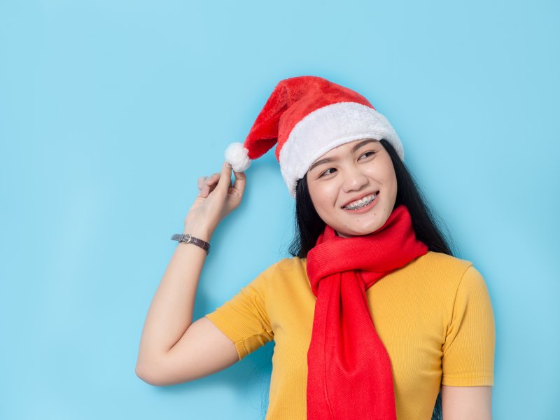 Woman with braces in a Santa hat
