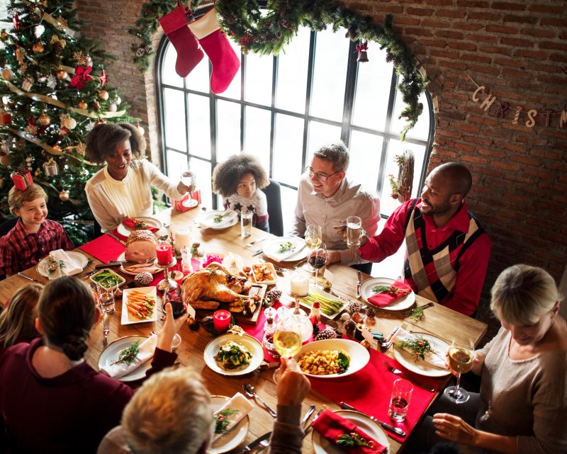 A family enjoying a holiday meal while one of the children wears braces