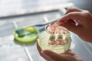 Person grabbing their retainer
